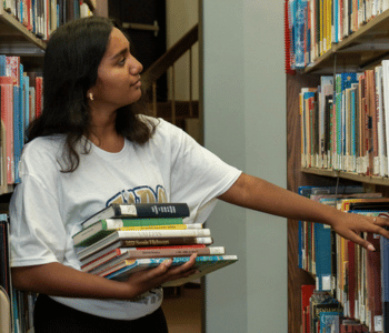 A student perusing the books